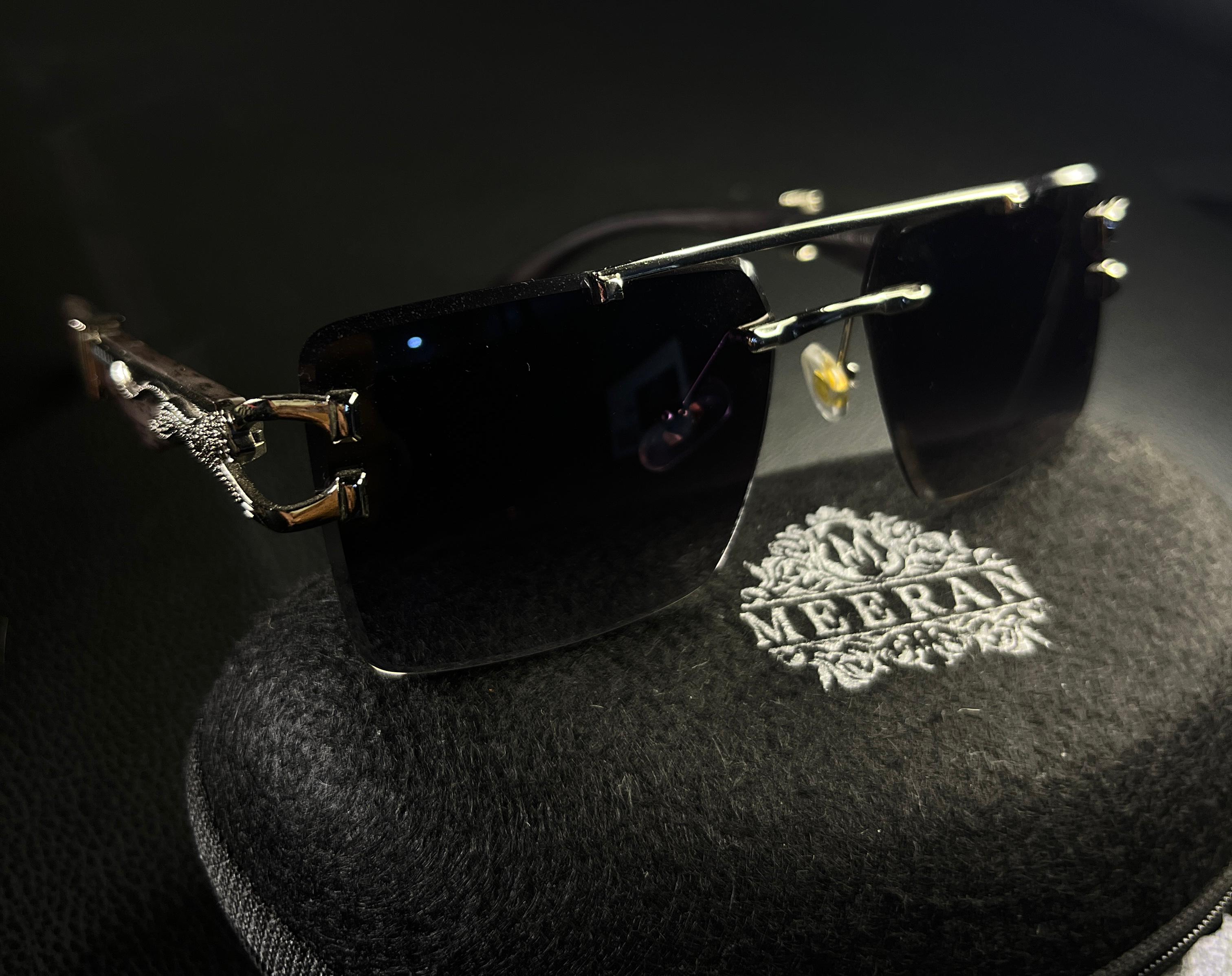 Meeran jaguar sunglasses with blue lenses and a black/gold frame, featuring UV protection